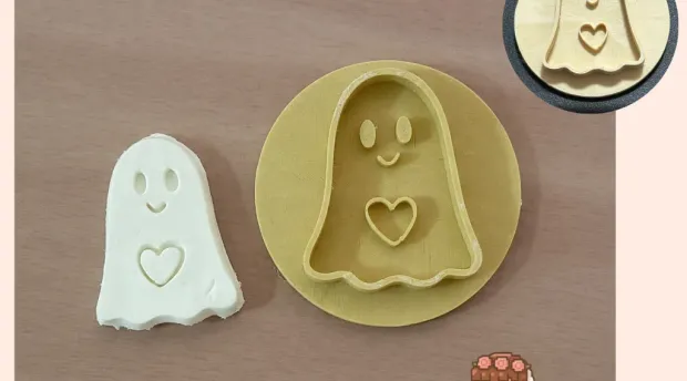 Ghost holding a heart, cookie cutter and clay stamp